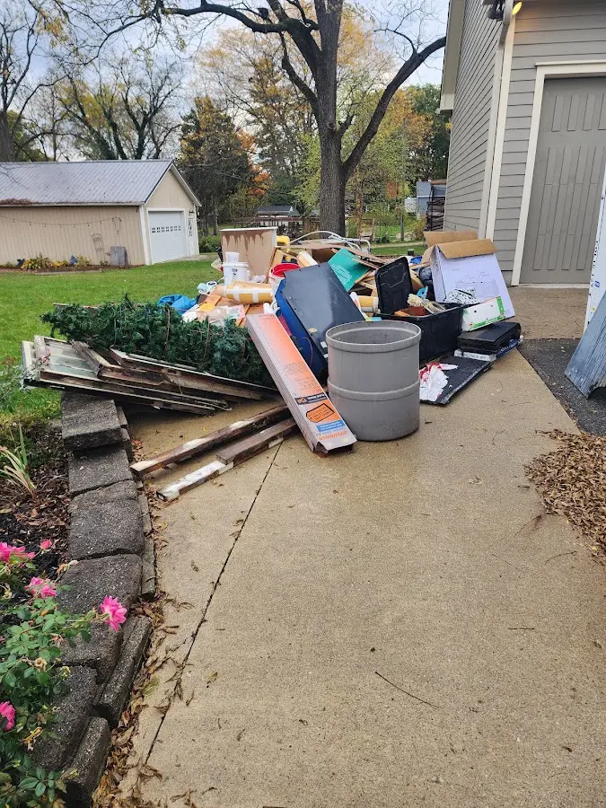 Dumpster being loaded with debris for Estate Cleanout Dumpster Rental in Shelbyville